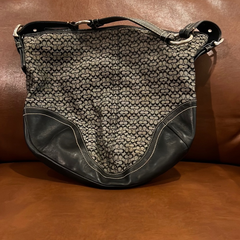 Coach black handbag small Cs and leather accents/trim/shoulder strap.
